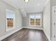 Bedroom with hardwood floors, two windows, and neutral gray paint at 1360 Flora Dr, Conyers, GA 30094