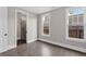 This bedroom has hardwood floors and two windows providing lots of natural light at 1360 Flora Dr, Conyers, GA 30094