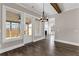 Bright dining area features hardwood floors, a modern chandelier, and access to the outdoor living space at 1360 Flora Dr, Conyers, GA 30094