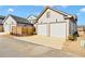 Modern two-car garage with a driveway and a wooden fence at 1360 Flora Dr, Conyers, GA 30094