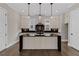 Bright kitchen with a kitchen island featuring a farmhouse sink, modern appliances, and stylish pendant lighting at 1360 Flora Dr, Conyers, GA 30094