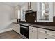 Modern kitchen features stainless steel appliances, shaker cabinets and dark backsplash at 1360 Flora Dr, Conyers, GA 30094