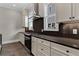 Modern kitchen features stainless steel appliances, shaker cabinets and dark backsplash at 1360 Flora Dr, Conyers, GA 30094