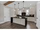 Open-concept kitchen with stainless steel appliances, a large island, and stylish pendant lighting at 1360 Flora Dr, Conyers, GA 30094