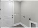 The laundry room features tiled floors and white cabinets, ready for appliances at 1360 Flora Dr, Conyers, GA 30094