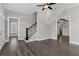 Living room featuring wood floors, stairs with black metal railings, and entryways to other rooms in the home at 1360 Flora Dr, Conyers, GA 30094