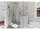 Modern glass shower featuring white marble tile and a built-in shower bench at 1360 Flora Dr, Conyers, GA 30094