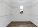 Walk-in closet featuring overhead shelving and window at 1360 Flora Dr, Conyers, GA 30094