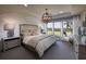 Serene primary bedroom with a tray ceiling, large windows, and stylish furnishings at 2446 Naples St, Hoschton, GA 30548