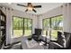 Bright sunroom with lots of natural light, comfortable seating, and a view of the green backyard at 2446 Naples St, Hoschton, GA 30548
