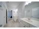 Bathroom with double sinks, ceramic tile flooring, and updated lighting at 5160 Meridian Pass, Cumming, GA 30028