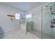 Bright bathroom featuring a glass-enclosed shower, soaking tub, and neutral tile flooring at 5160 Meridian Pass, Cumming, GA 30028