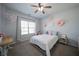 Cozy bedroom with carpet flooring, ceiling fan, and bright light at 5160 Meridian Pass, Cumming, GA 30028