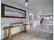 Inviting entryway with stylish mirror and table, leading to a bright, modern kitchen at 5160 Meridian Pass, Cumming, GA 30028