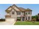 Charming two-story home featuring a brick facade and well-maintained landscaping at 5160 Meridian Pass, Cumming, GA 30028