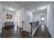 Upstairs hallway with hardwood flooring, leading to bedrooms and baths at 5160 Meridian Pass, Cumming, GA 30028