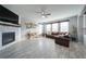 Bright living room with fireplace, ceiling fan, and gray flooring, offering a cozy and inviting atmosphere at 5160 Meridian Pass, Cumming, GA 30028