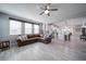 Open concept living room and kitchen with hardwood floors, ceiling fan and large windows offer a bright and open space at 5160 Meridian Pass, Cumming, GA 30028