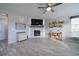 Cozy living room with a stone fireplace, ceiling fan, and hardwood floors. Lots of natural light at 5160 Meridian Pass, Cumming, GA 30028