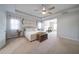 Spacious bedroom with neutral colors, ceiling fan, carpeted floors, and an adjacent room for exercising at 5160 Meridian Pass, Cumming, GA 30028