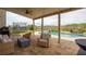 Covered patio with wicker furniture overlooking a pool and backyard at 5160 Meridian Pass, Cumming, GA 30028