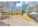 Large backyard with a patio, fire pit, and outbuilding at 1042 Helen St, Forest Park, GA 30297