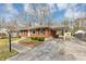 Exterior view of the brick home with a carport and driveway at 1042 Helen St, Forest Park, GA 30297