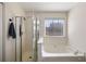 Bathroom features a bathtub and separate glass-enclosed shower stall at 2715 Kaley Nw Ln, Kennesaw, GA 30152