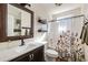 Bathroom with a decorative mirror, floral shower curtain, and open shelving at 2715 Kaley Nw Ln, Kennesaw, GA 30152