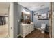 Stylish bathroom with a vanity, framed mirror, and wood-look tile flooring at 2715 Kaley Nw Ln, Kennesaw, GA 30152