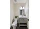 Elegant half bathroom featuring a modern vanity, framed mirror, and stylish fixtures at 2715 Kaley Nw Ln, Kennesaw, GA 30152