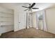 Bright bedroom with a ceiling fan, carpet, and built-in shelves at 2715 Kaley Nw Ln, Kennesaw, GA 30152
