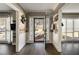 Inviting foyer with wood accents, modern flooring, and views of the home's exterior at 2715 Kaley Nw Ln, Kennesaw, GA 30152