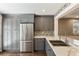 Modern kitchen with gray cabinetry, stainless steel appliances, and granite countertops at 2715 Kaley Nw Ln, Kennesaw, GA 30152