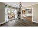 Bright living room features a large window, a modern light fixture, and hardwood floors at 2715 Kaley Nw Ln, Kennesaw, GA 30152