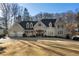 Stately home featuring a well-manicured lawn, three-car garage, and elegant facade at 3258 Teton Se Dr, Atlanta, GA 30339