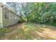 Backyard with green grass leading to a view of the home's exterior at 5500 Marbut Forest Way, Lithonia, GA 30058