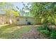 Backyard showcasing green grass, bushes, an AC unit, and the exterior of the home at 5500 Marbut Forest Way, Lithonia, GA 30058