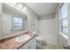 Bathroom featuring an oval sink, white toilet, and tub with tiled walls at 5500 Marbut Forest Way, Lithonia, GA 30058