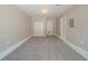 Carpeted room with ample space, featuring a double closet and two doors at 5500 Marbut Forest Way, Lithonia, GA 30058