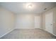 Bedroom featuring neutral walls, white doors, and plush neutral carpeting at 5500 Marbut Forest Way, Lithonia, GA 30058