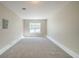 Spacious carpeted bedroom with a window providing plenty of natural light at 5500 Marbut Forest Way, Lithonia, GA 30058