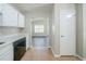 Galley kitchen featuring tan tile flooring, and white cabinets and countertops at 5500 Marbut Forest Way, Lithonia, GA 30058