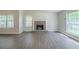 Inviting living room with hardwood floors, a brick fireplace and large windows for natural light at 5500 Marbut Forest Way, Lithonia, GA 30058