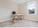 Neutral bedroom offers gray carpet, natural light from the window, and a white desk at 677 Brennan Dr, Decatur, GA 30033