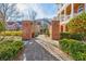 Community entrance featuring brick pillars, an archway, and lush landscaping for a welcoming feel at 677 Brennan Dr, Decatur, GA 30033