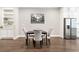 Modern dining room featuring a table with four chairs, white cabinets and stainless steel fridge at 677 Brennan Dr, Decatur, GA 30033