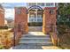Charming brick entrance featuring a stylish archway and well-maintained landscaping at 677 Brennan Dr, Decatur, GA 30033