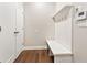 Hallway and mudroom features wood floors, wall hooks, and a built-in bench seat at 677 Brennan Dr, Decatur, GA 30033