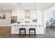 Bright kitchen boasts white cabinets, stainless steel appliances, and a large center island with bar seating at 677 Brennan Dr, Decatur, GA 30033